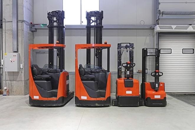 forklifts maneuvering through stacked inventory shelves